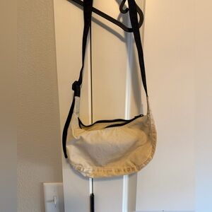 Small cream colored baggu crescent bag